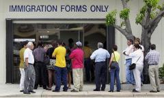 A line forms near the entrance of the Immigration and Naturalization Service office in Miami. (Photo by RHONA WISE/AFP via Getty Images)